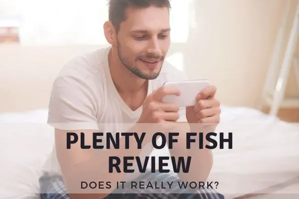Plenty Of Fish Review overlaid on image of man looking at mobile phone screen
