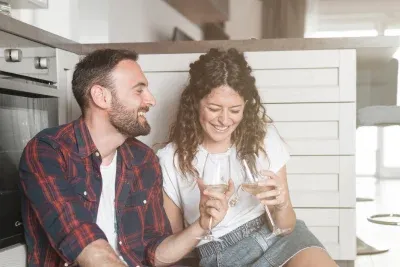 Couple in Akron enjoying wine in their kitchen.