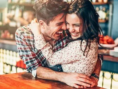 Happy couple in love sitting at a diner