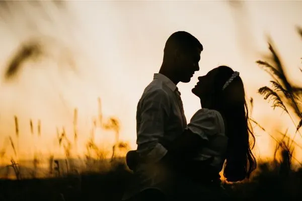 Couple standing at sunset in a Colorado field