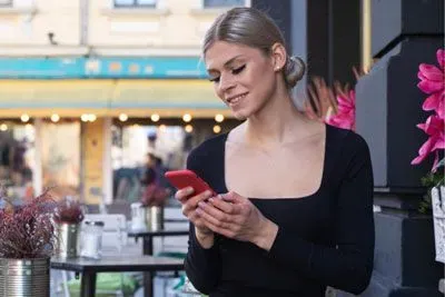 Waitress swiping on a dating app during a break