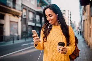 Woman laughing at a text message